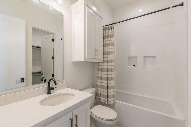 bathroom featuring toilet, shower / tub combo with curtain, and vanity