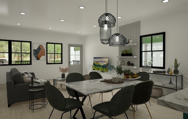 dining area featuring a large fireplace and light hardwood / wood-style floors