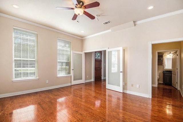 interior space featuring crown molding, dark hardwood / wood-style flooring, ceiling fan, and ensuite bathroom