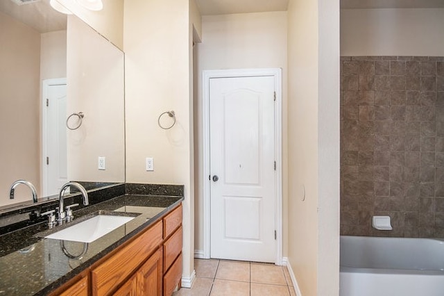 bathroom featuring vanity, a bathtub, and tile patterned floors