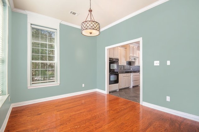 interior space with crown molding and dark hardwood / wood-style flooring