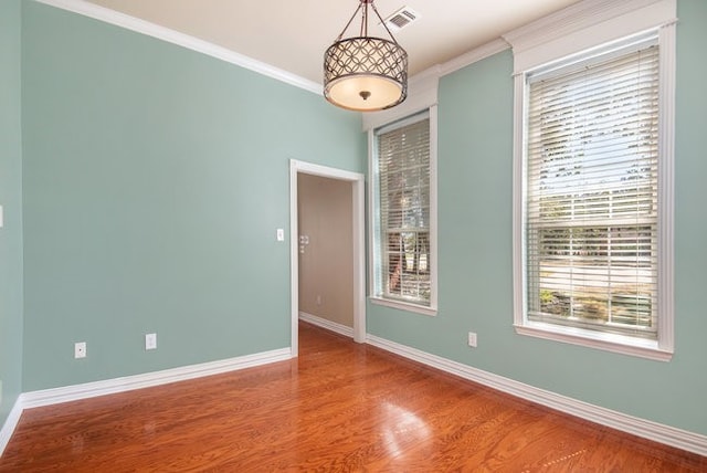 unfurnished room featuring ornamental molding and hardwood / wood-style floors