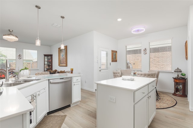 kitchen featuring light hardwood / wood-style flooring, dishwasher, and a kitchen island