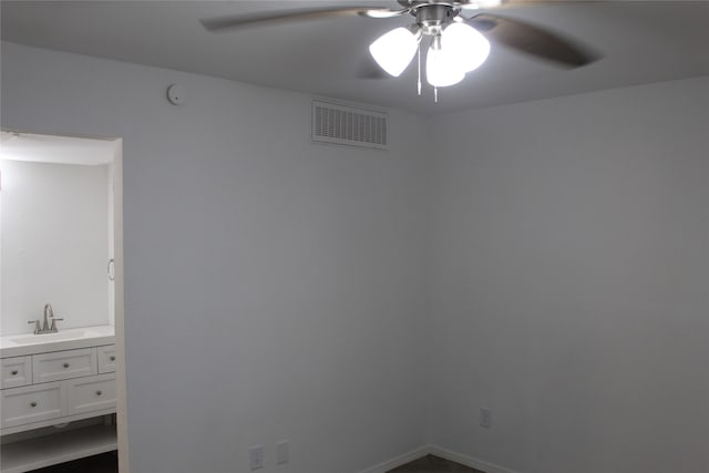 empty room with ceiling fan and sink