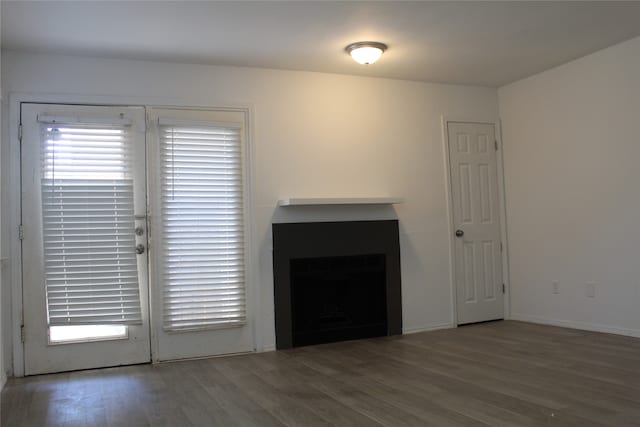 unfurnished living room with dark hardwood / wood-style floors