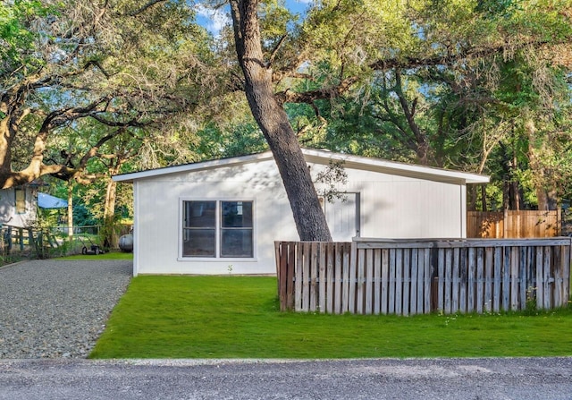 view of side of home with a yard