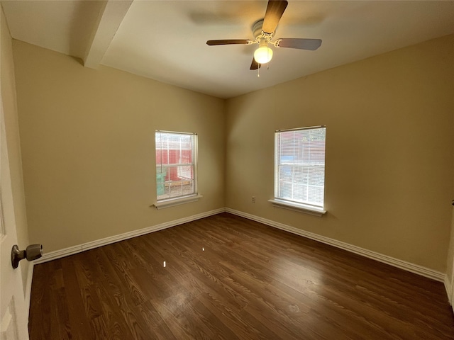 empty room with ceiling fan and dark hardwood / wood-style flooring