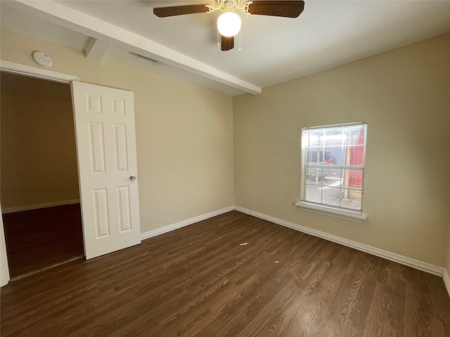 empty room with beam ceiling, dark hardwood / wood-style floors, and ceiling fan