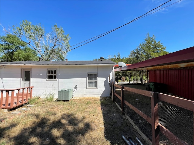 rear view of property with cooling unit