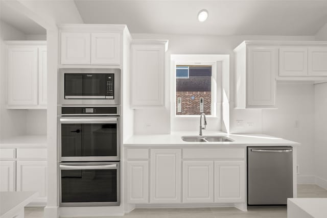 kitchen with white cabinetry, appliances with stainless steel finishes, and sink