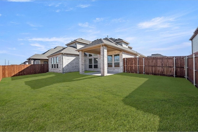 back of house with a lawn and a patio area