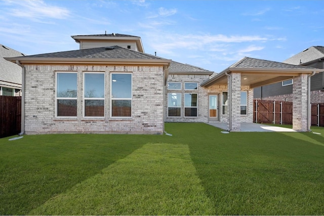 rear view of house featuring a lawn