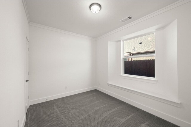 spare room featuring ornamental molding and carpet