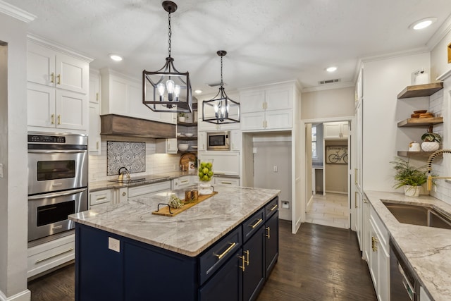 kitchen with dark hardwood / wood-style floors, sink, hanging light fixtures, white cabinets, and appliances with stainless steel finishes