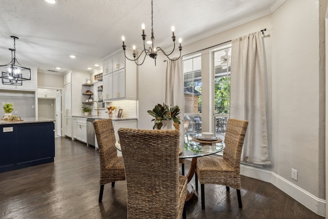 dining space with ornamental molding, a chandelier, and dark hardwood / wood-style flooring