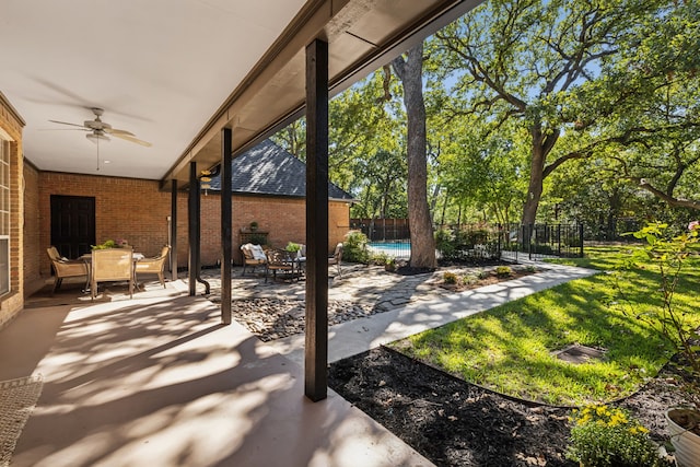 view of patio / terrace featuring ceiling fan and a fenced in pool