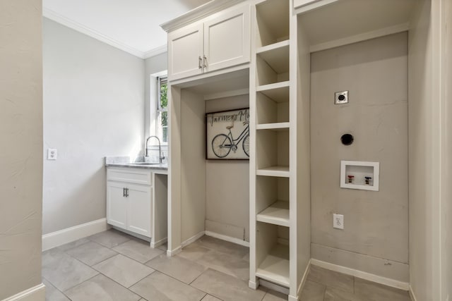 laundry area with washer hookup, cabinets, hookup for an electric dryer, sink, and ornamental molding