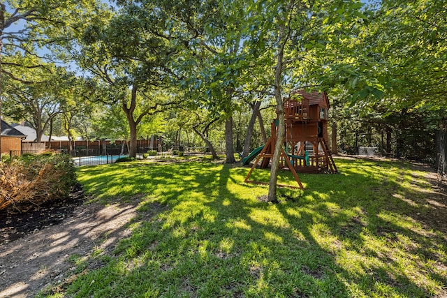 view of yard with a playground and a fenced in pool