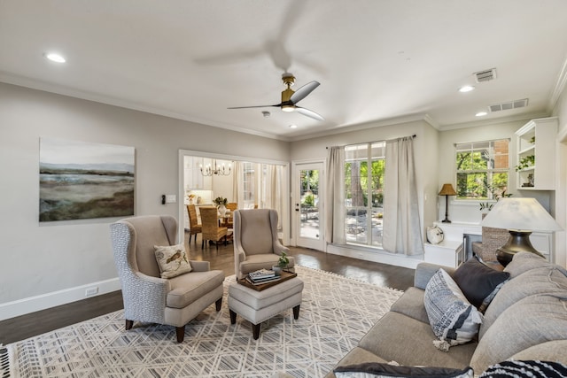 living room featuring plenty of natural light, ornamental molding, and wood-type flooring