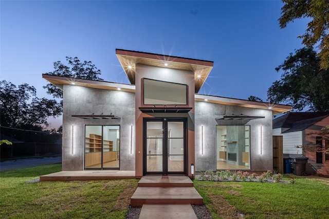 exterior entry at dusk with a lawn