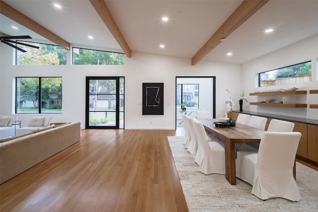 dining area with high vaulted ceiling, light hardwood / wood-style flooring, ceiling fan, and beam ceiling