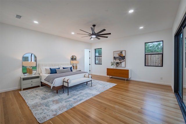 bedroom with light hardwood / wood-style floors and ceiling fan