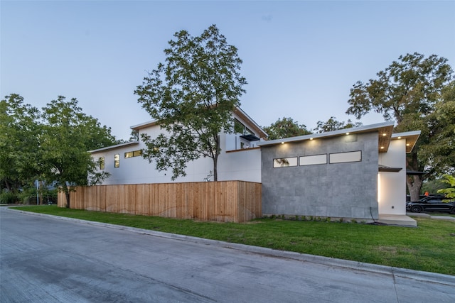 view of side of home featuring a lawn