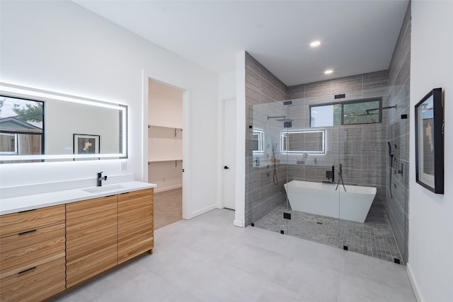 bathroom featuring tile patterned floors, vanity, and plus walk in shower