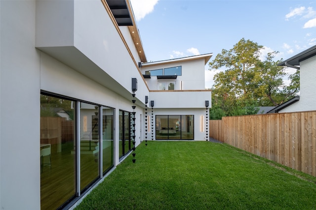 rear view of property featuring a yard