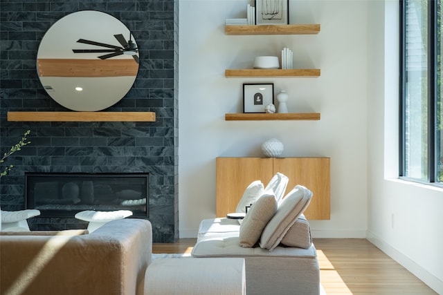 sitting room with a fireplace and hardwood / wood-style floors