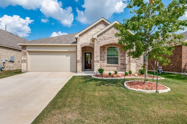 view of front of home with a front yard and a garage