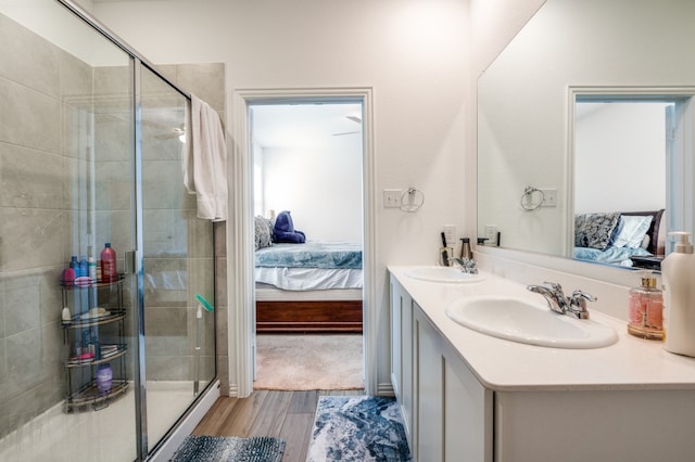 bathroom featuring vanity, hardwood / wood-style floors, and a shower with door