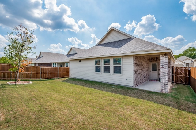 back of property with a patio and a yard