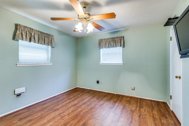 empty room featuring wood-type flooring and ceiling fan