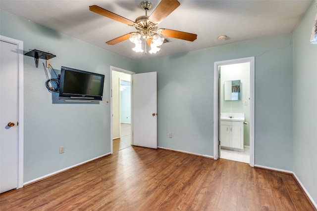 unfurnished bedroom with connected bathroom, ceiling fan, and hardwood / wood-style floors