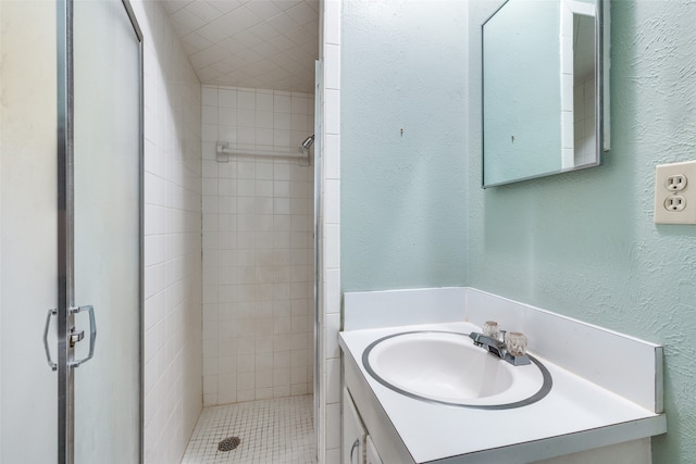 bathroom featuring vanity and tiled shower