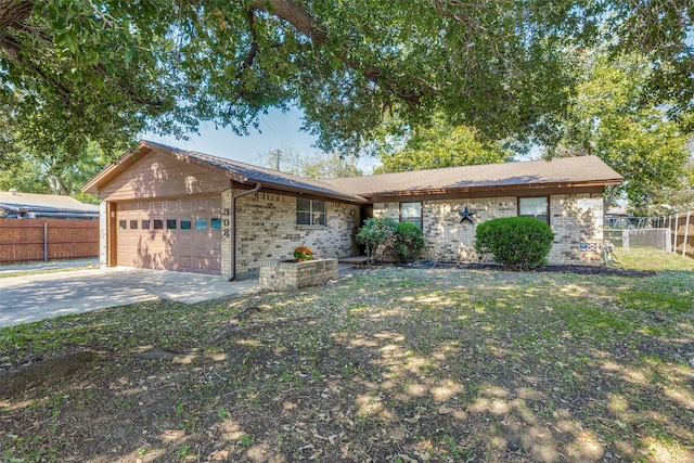 ranch-style house featuring a front yard and a garage