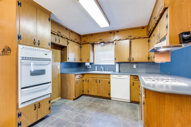 kitchen with backsplash, white appliances, light tile patterned flooring, and sink