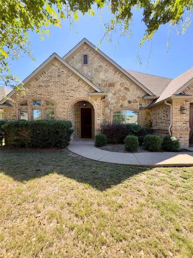 view of front facade with a front lawn and a patio area