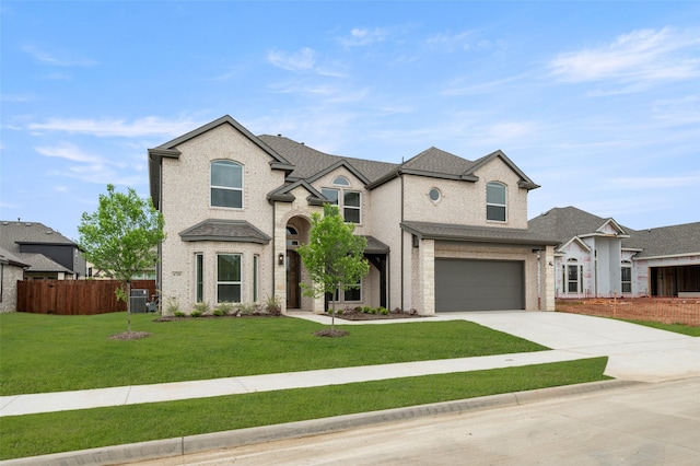 view of front of house with brick siding, fence, a garage, concrete driveway, and a front lawn