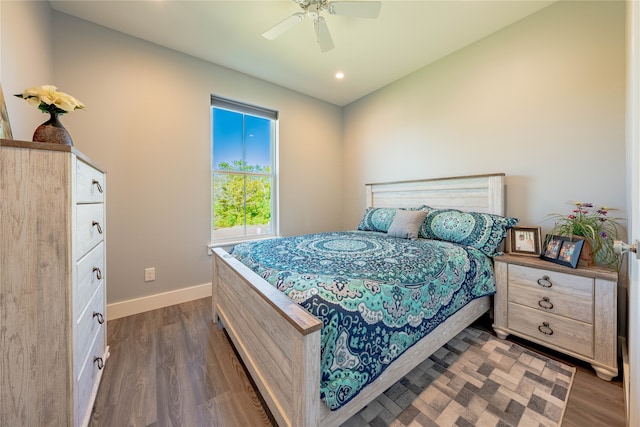 bedroom with ceiling fan and dark hardwood / wood-style floors