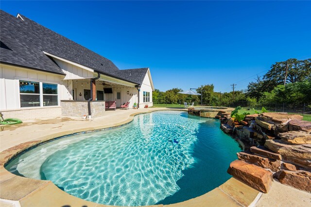 view of swimming pool featuring a patio and an in ground hot tub