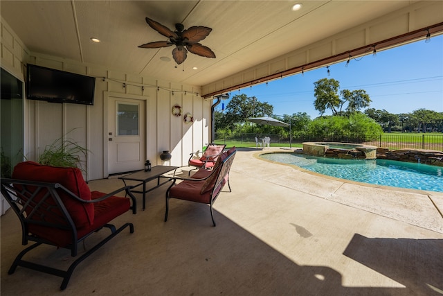 view of pool featuring an in ground hot tub, ceiling fan, and a patio area