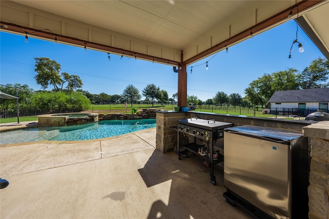 view of swimming pool with a grill, an in ground hot tub, and a patio area