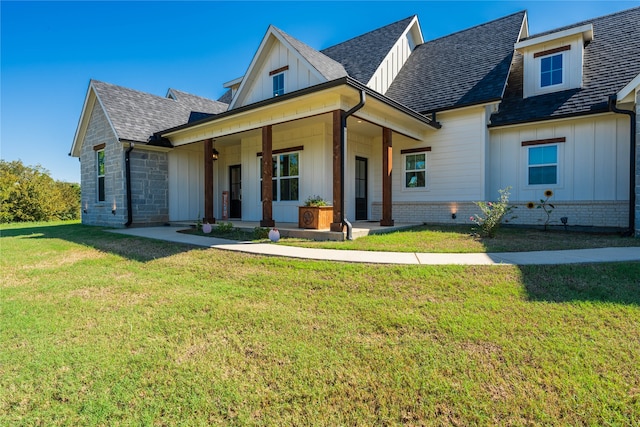 view of front facade with a front yard and a porch