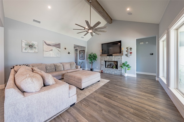 living room with dark wood-type flooring, high vaulted ceiling, a brick fireplace, beam ceiling, and ceiling fan