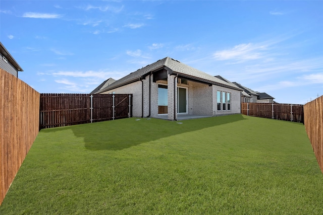 back of house with a lawn