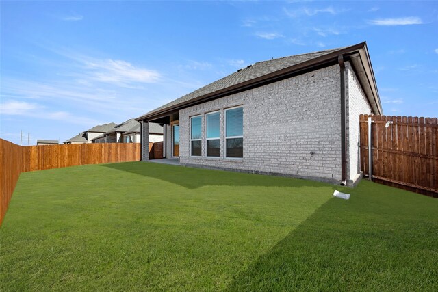 rear view of house with a lawn