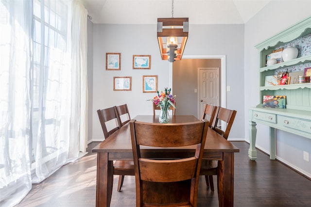 dining area featuring a chandelier, a healthy amount of sunlight, and dark hardwood / wood-style flooring