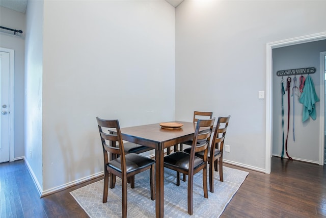 dining space with dark hardwood / wood-style floors